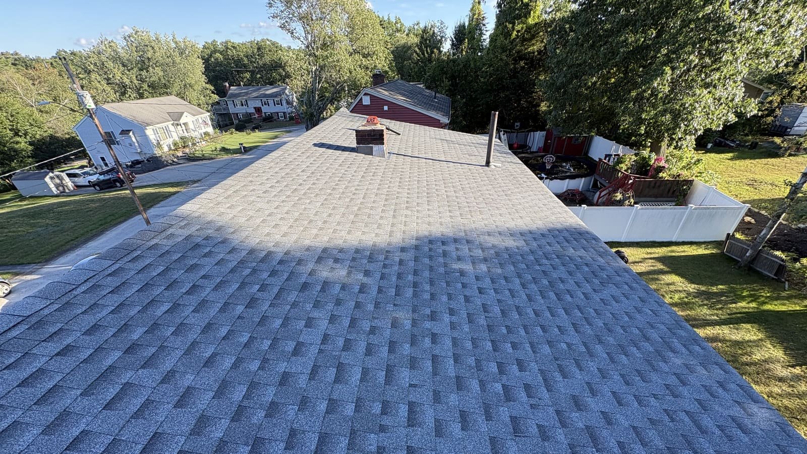Completed architectural shingle roof viewed from the ridge on a residential home in Southern NH