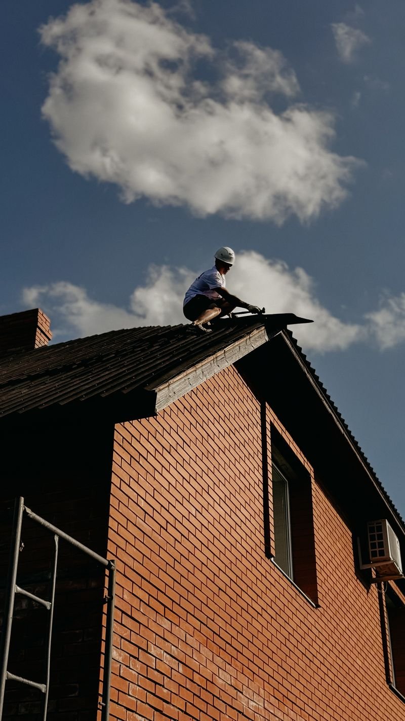 Roofing contractor inspecting a residential roof