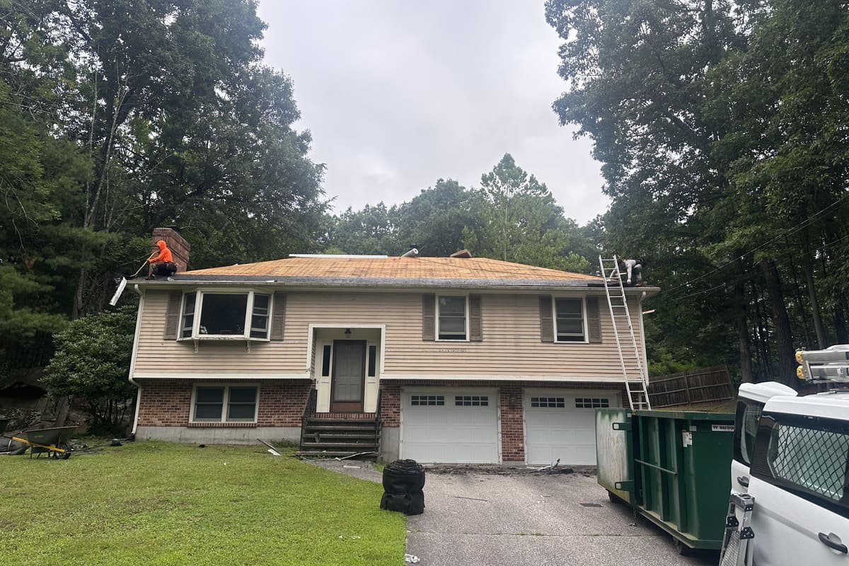 Prescott Roofing crew performing a roof tear-off on a residential home in Southern NH
